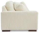 Ashley Furniture Lindyn sectional sofa with plush cushions and modern design, shown in a spacious living room setting.