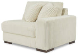 Ashley Furniture Lindyn sectional sofa with plush cushions and neutral fabric, shown in a modern living room setting.