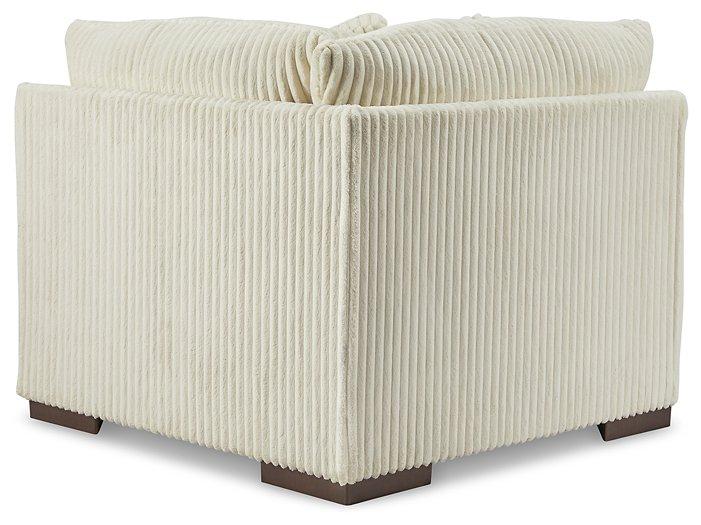 Ashley Furniture Lindyn sectional sofa with plush cushions and modern design, shown in a cozy living room setting.