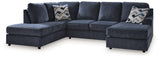 Ashley Furniture Albar Place sectional sofa with plush cushions and modern design, shown in a spacious living room setting.