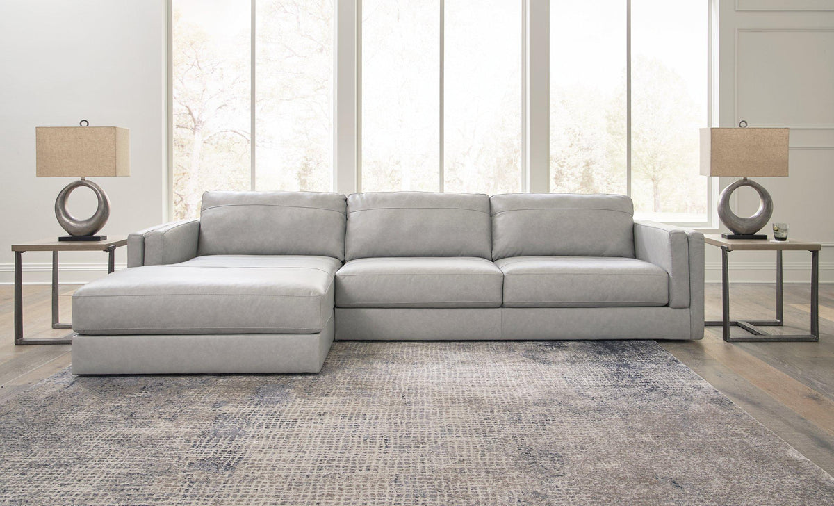 Ashley Furniture Amiata sectional with chaise, showing a modern fabric sofa with plush cushions and a spacious chaise lounge.
