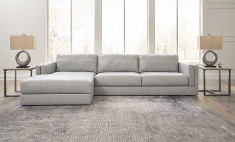 Ashley Furniture Amiata sectional with chaise, showing a modern fabric sofa with plush cushions and a spacious chaise lounge.