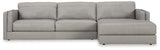Ashley Furniture Amiata sectional with chaise, featuring plush fabric upholstery and modern design, shown in a spacious living room setting.