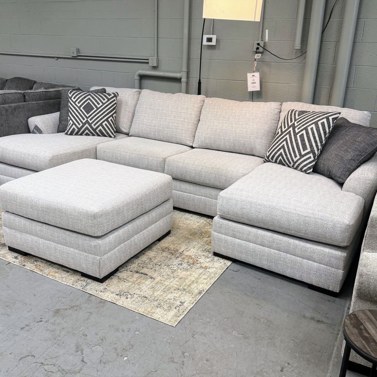 Ashley Furniture Koralynn sectional with chaise, featuring plush cushions and neutral fabric for a modern living room look.