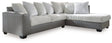Ashley Furniture Clairette sectional with chaise, featuring plush upholstery and modern design, shown in a spacious living room setting.