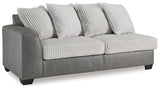 Ashley Furniture Clairette Court sectional with chaise, featuring plush upholstery and modern design in a spacious living room setting.