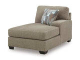 Ashley Furniture Newellen Sleeper Sectional with Chaise, featuring plush cushions and a contemporary design in a spacious living room setting.