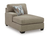 Ashley Furniture Newellen Sleeper Sectional with Chaise, angled view showing plush cushions and modern design.
