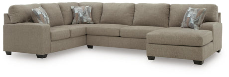 Ashley Furniture Newellen Sleeper Sectional with chaise featuring plush cushions and neutral fabric upholstery.
