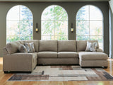 Ashley Furniture Newellen Sleeper Sectional with Chaise, featuring plush fabric and modern design in a cozy living room setting.