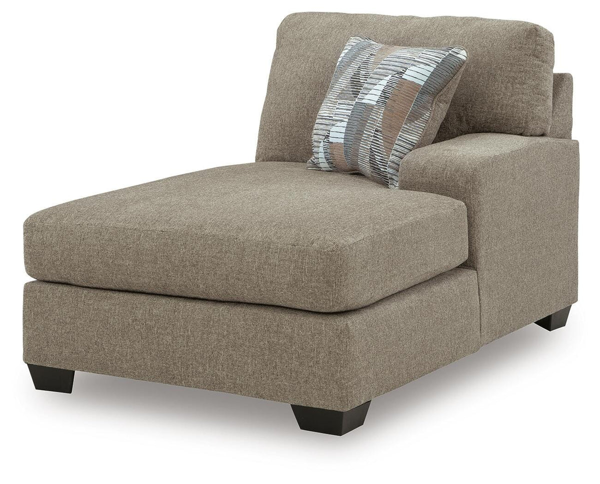 Ashley Furniture Newellen sleeper sectional with chaise, showing a modern fabric sectional sofa with chaise lounge in a stylish living room.