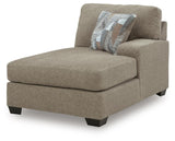 Ashley Furniture Newellen sleeper sectional with chaise, showing a modern fabric sectional sofa with chaise lounge in a stylish living room.