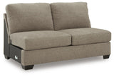 Ashley Furniture Newellen sleeper sectional with chaise, showing plush fabric, modern design, and spacious seating arrangement.