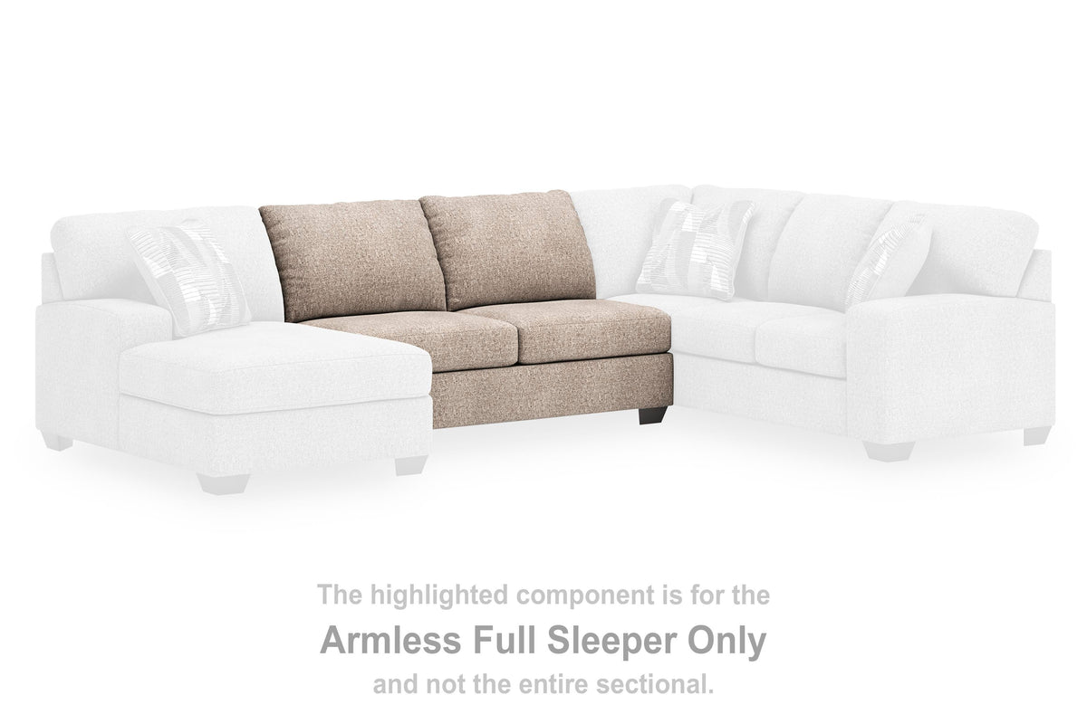 Ashley Furniture Newellen sleeper sectional with chaise, featuring plush upholstery and modern design, shown in a stylish living room setting.