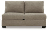 Ashley Furniture Newellen sleeper sectional with chaise, showing plush fabric upholstery and spacious seating in a modern living room.