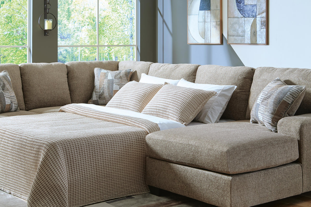 Ashley Furniture Newellen Sleeper Sectional with Chaise, modern sectional sofa with chaise and fold-out bed, in neutral fabric.