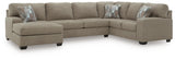 Ashley Furniture Newellen sleeper sectional with chaise, featuring plush upholstery and a spacious lounging area.