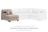 Ashley Furniture Newellen sleeper sectional with chaise, featuring plush cushions and a modern design in neutral upholstery.