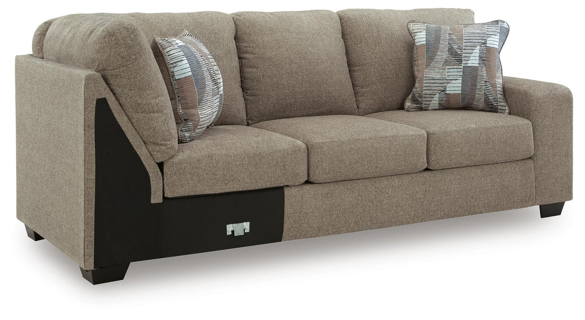 Ashley Furniture Newellen sleeper sectional with chaise, showing a modern fabric sofa with plush cushions and a chaise lounge at an angle.