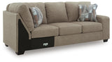 Ashley Furniture Newellen sleeper sectional with chaise, showing a modern fabric sofa with plush cushions and a chaise lounge at an angle.