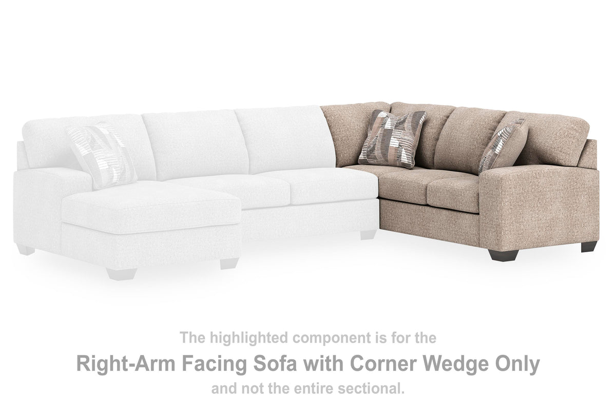 Ashley Furniture Newellen sleeper sectional with chaise, showcasing plush fabric, reclining seats, and a spacious sitting area.
