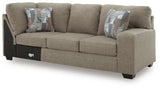 Ashley Furniture Newellen sleeper sectional with chaise, featuring plush cushions and modern design, shown from an angled view.