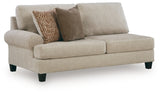 Ashley Furniture Steelwater Retreat sectional with chaise, showing plush beige fabric, modern design, and spacious seating arrangement.