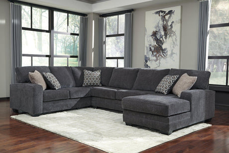 Ashley Furniture Tracling 3-Piece sectional with chaise, featuring plush cushions and modern design in a cozy living room setting.