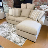 Ashley Furniture Lennox sectional sofa with chaise, featuring plush cushions and modern design in a cozy living room setting.