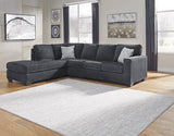 Ashley Furniture Altari sleeper sectional with chaise, showing plush fabric upholstery and spacious design with a built-in sleeping area.