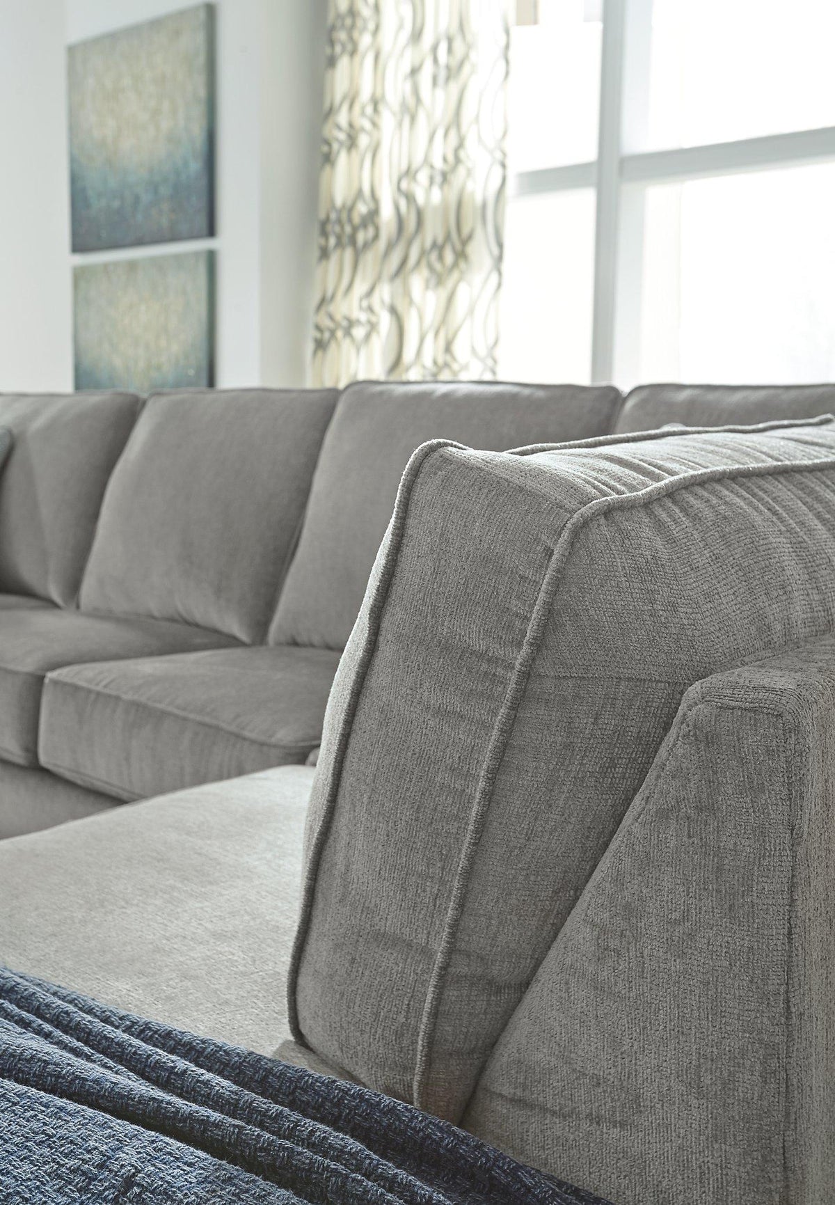 Ashley Furniture Altari Sleeper Sectional with Chaise, beige fabric, modern design, with a built-in sleeper and chaise lounge.