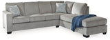 Ashley Furniture Altari sleeper sectional with chaise in neutral fabric, featuring plush cushions and a modern design.