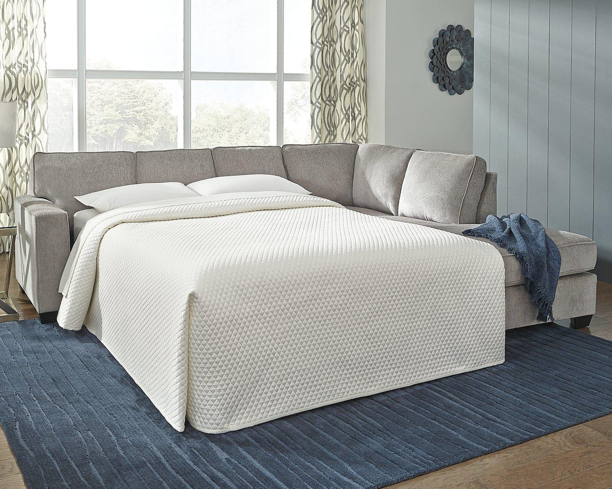 Ashley Furniture Altari sleeper sectional with chaise, showcasing plush fabric upholstery and modern design in a living room setting.
