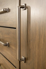 Cabalynn dining server by Ashley Furniture showing a wooden kitchen storage piece with drawers and cabinet doors.