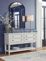 Ashley Furniture Montelaine dining server with wooden finish, featuring multiple drawers and cabinet storage for elegant dining room organization.