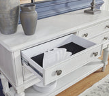 Montelaine dining server by Ashley Furniture featuring a sleek wooden design with multiple storage compartments.