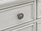 Montelaine dining server by Ashley Furniture featuring a spacious surface and storage drawers in a classic wood finish.