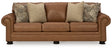 Ashley Furniture Carianna sofa sleeper with beige fabric, showing the front view with plush cushions and a modern design.
