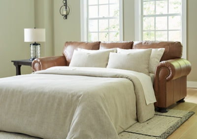 Ashley Furniture Carianna Sofa Sleeper with plush upholstery and fold-out bed, ideal for guest accommodations.