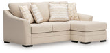 Ashley Furniture Lango sleeper sofa with chaise, shown from an angled view, featuring plush upholstery and a spacious seating area.