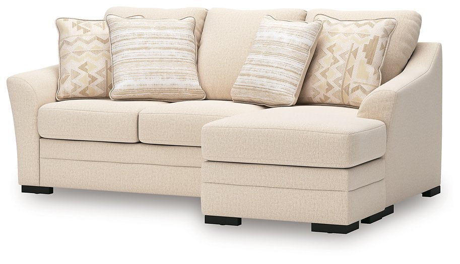 Ashley Furniture Lango Sleeper Sofa with chaise, featuring plush cushions and a modern design, shown from an angled view.