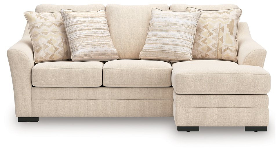 Ashley Furniture Lango Sofa Chaise Sleeper with beige upholstery and plush cushions, shown from a front head-on view.