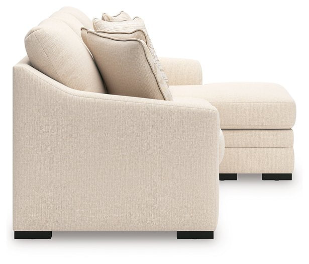 Ashley Furniture Lango sofa sleeper with chaise lounge, featuring a modern design and plush upholstery in a living room setting.