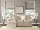 Ashley Furniture Lango Sofa Chaise Sleeper in gray fabric, featuring plush cushions and a built-in recliner for versatile comfort