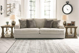 Ashley Furniture Soletren sofa sleeper with beige fabric upholstery and plush cushions, showcasing its convertible design.