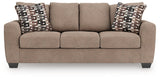 Ashley Furniture Triston-Peaks sofa sleeper with plush fabric, featuring a fold-out bed, and contemporary design in a living room setting.