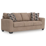 Ashley Furniture Triston-Peaks sofa sleeper with plush fabric and convertible design, shown from an angled view.