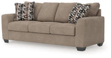 Ashley Furniture Triston-Peaks sofa sleeper showing a modern gray fabric sofa with fold-out bed and plush cushions, angled view.