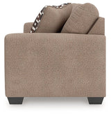 Ashley Furniture Triston-Peaks sofa sleeper with plush fabric, side view showing the bed extension and modern design.