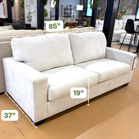 Ashley Furniture Camden Sleeper Sofa with plush fabric, modern design, and open bed in a cozy living room setting.